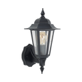 A classic black outdoor wall sconce with a clear glass lantern shade and a visible warm-toned Edison bulb, shown against a solid white background.