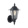 A classic black outdoor wall sconce with a clear glass lantern shade and a visible warm-toned Edison bulb, shown against a plain white background.