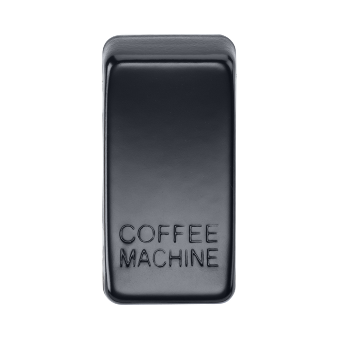 Black rectangular object with 'COFFEE MACHINE' engraving on a white background