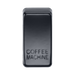 Black rectangular object with 'COFFEE MACHINE' engraving on a white background