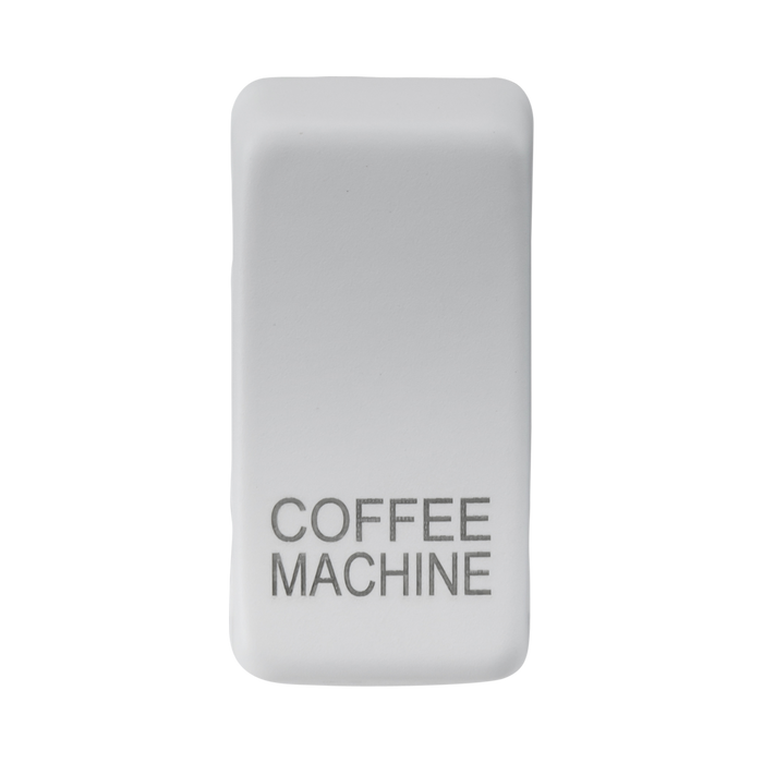 White rectangular object with 'COFFEE MACHINE' engraving on a white background