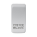 White rectangular object with 'COFFEE MACHINE' engraving on a white background