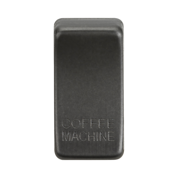 Smoked bronze rectangular object with 'COFFEE MACHINE' engraving on a white background