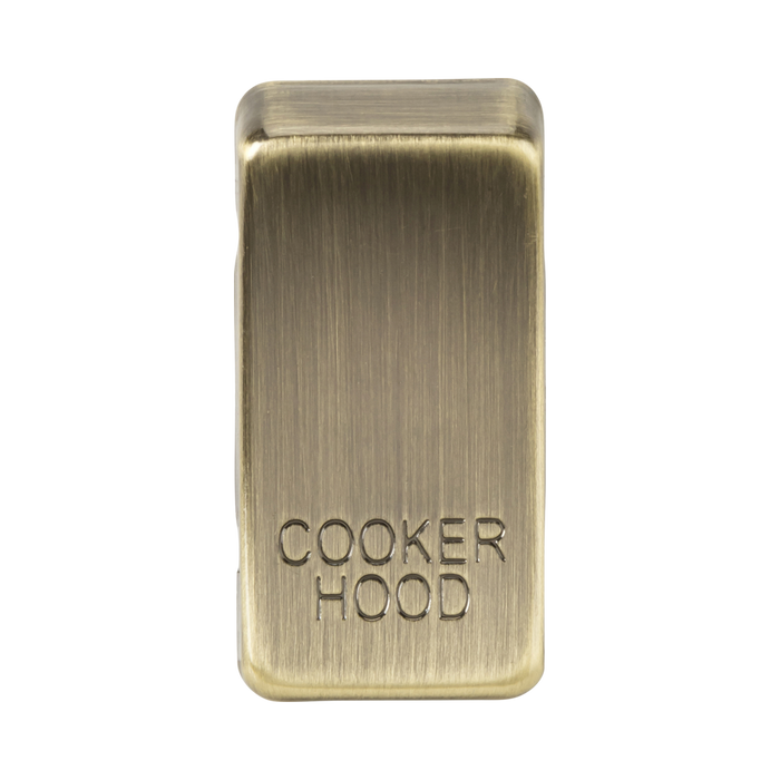 Brass rectangular object with 'Cooker Hood' engraving on a white background