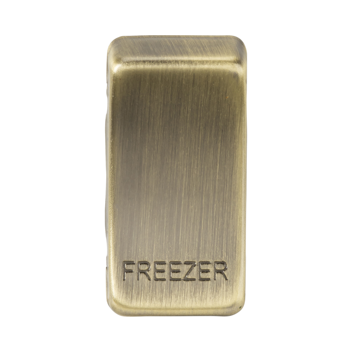 Brass-colored freezer indicator on a white background