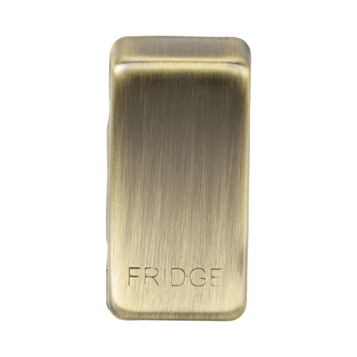 Brass rectangular object with 'FRIDGE' engraving on a white background