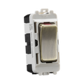 Electrical switch with brass rocker and white housing on a white background