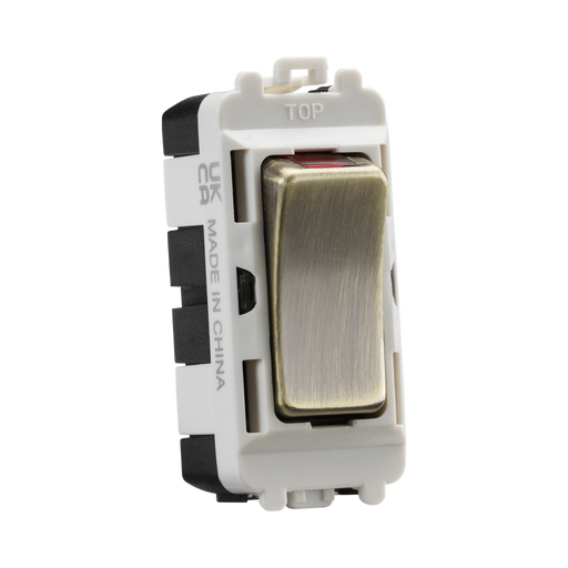 Electrical switch with brass rocker and white housing on a white background