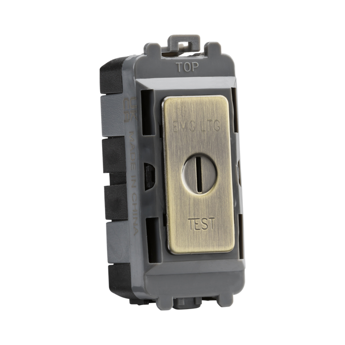 Brass electrical switch with 'EMG LTC' and 'TEST' labels on a white background