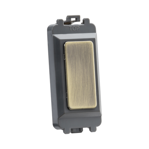 Brass switch with a gold faceplate on a white background