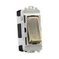 Toggle switch with brass rocker on a white background