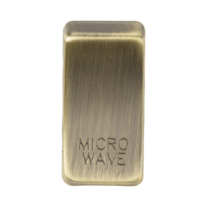 Rectangular brass object with 'MICROWAVE' engraving on a white background