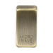 Rectangular brass object with 'MICROWAVE' engraving on a white background