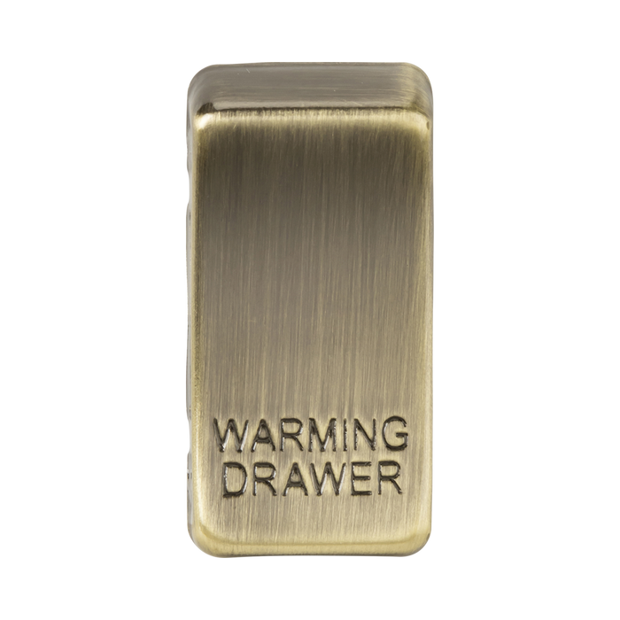 Brass rectangular object with 'Warming Drawer' engraving on a white background