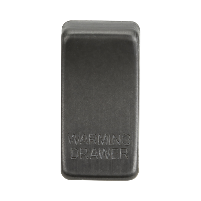 Smoked bronze rectangular object with 'Warming Drawer' engraving on a white background