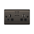 Black electrical socket with two plug sockets and two switches on a white background