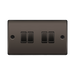 Black rectangular switch plate with four black switches on a white background