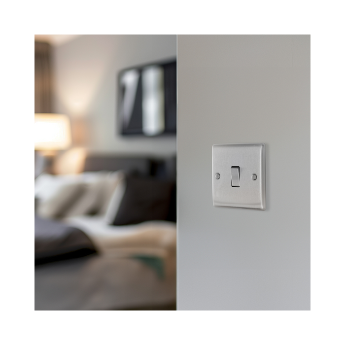 Metallic light switch on a white background bedroom setting