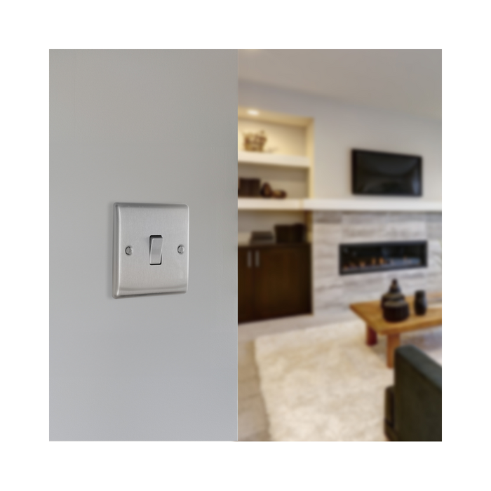 Metallic light switch on a white background living setting