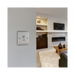 Metallic light switch on a white background living setting