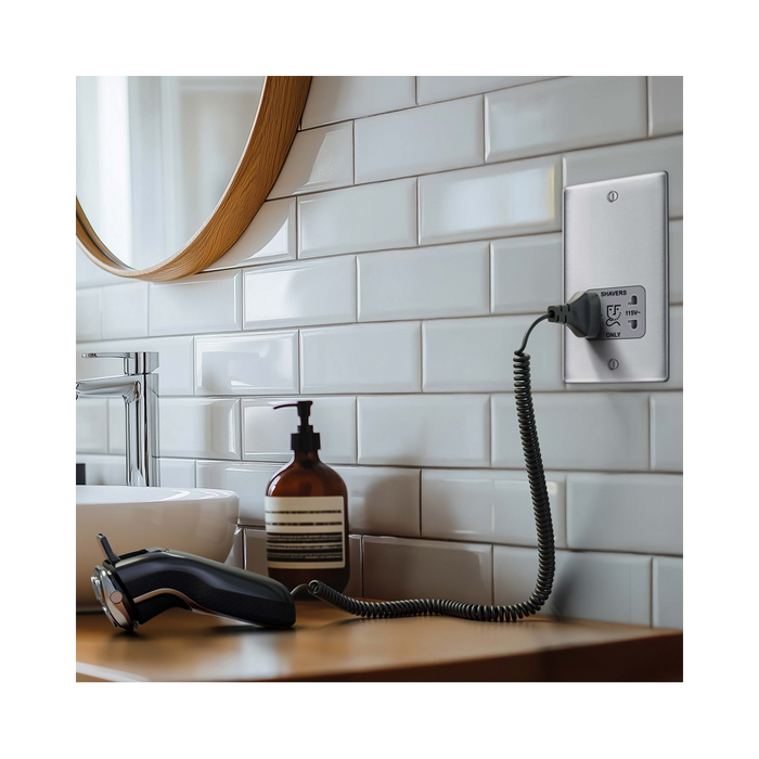 Metallic wall outlet with shaver socket label on a white background bathroom setting