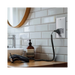 Metallic wall outlet with shaver socket label on a white background bathroom setting