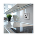 Metallic electrical socket with black inserts on a white background kitchen setting