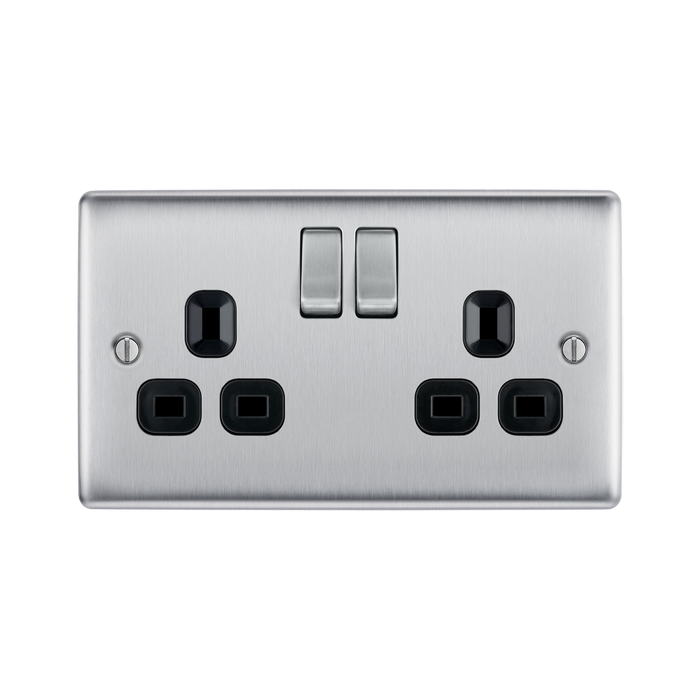 Metallic electrical socket with two black outlets and two silver rocker switches on a white background