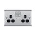 Metallic electrical socket with two black outlets and two silver rocker switches on a white background