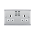 Metallic light switch with multiple sockets and switches on a white background