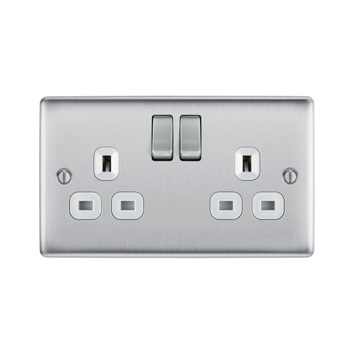 Metallic light switch with multiple sockets and switches on a white background