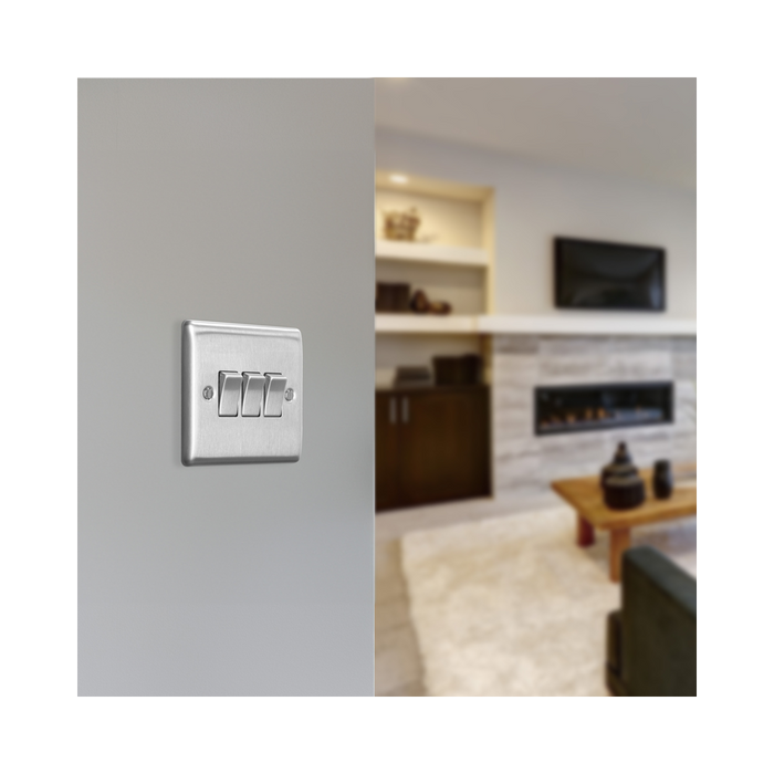 Metallic light switch panel with three toggle switches on a white background lounge setting
