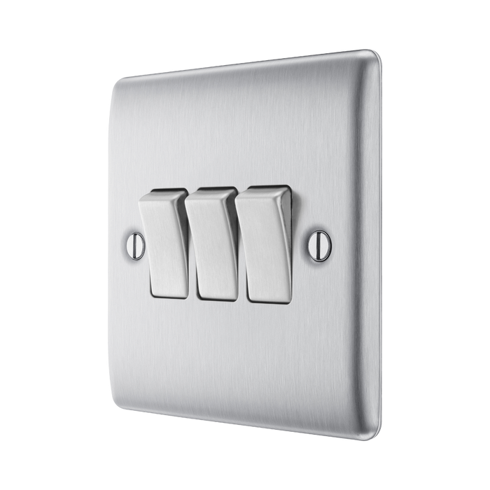 Metallic light switch panel with three toggle switches on a white background side