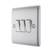 Metallic light switch panel with three toggle switches on a white background side