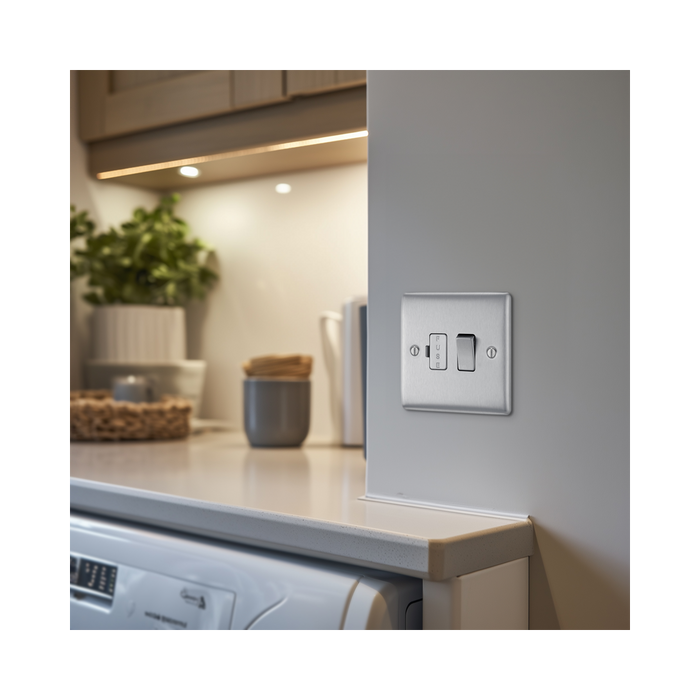Metallic light switch with two toggle switches on a white background kitchen setting