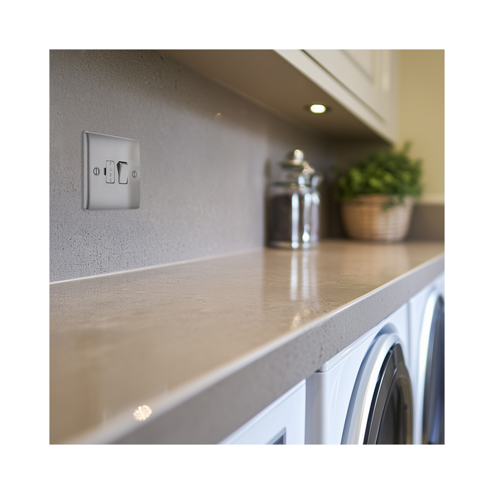 Metallic light switch with two toggle switches on a white background laundry setting