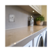 Metallic light switch with two toggle switches on a white background laundry setting