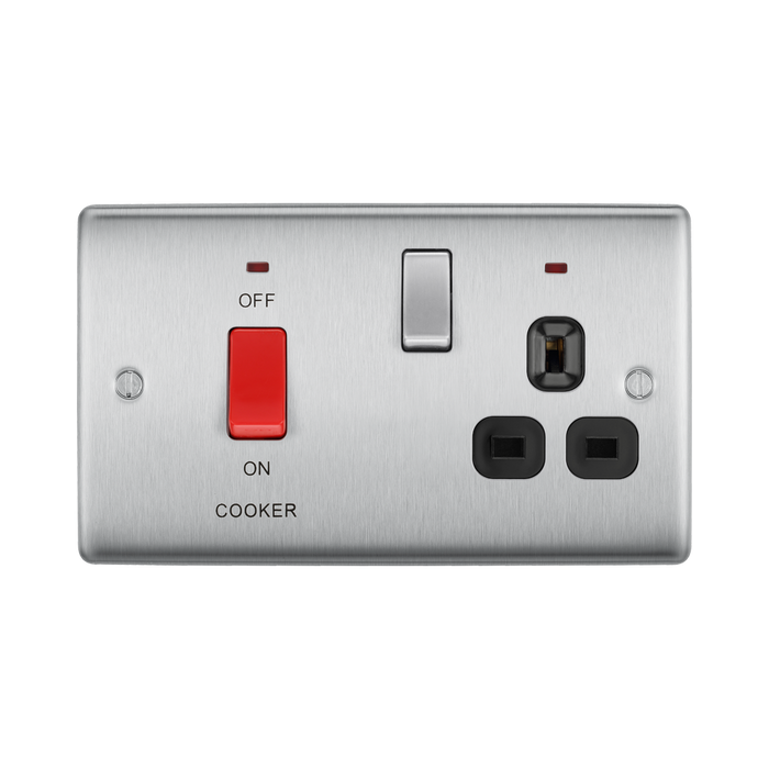 Metallic electrical switch with red button and black sockets on a white background