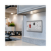 Metallic electrical switch with red button and multiple sockets on a white background kitchen