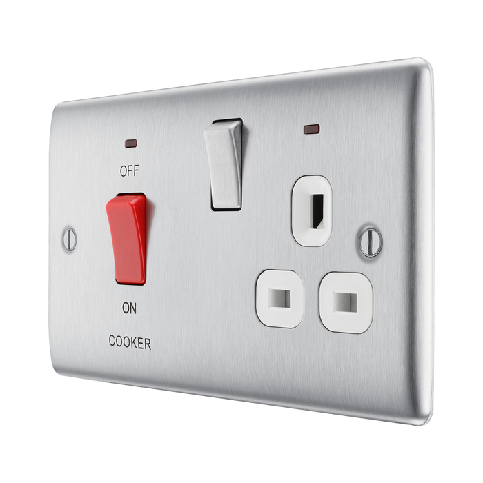 Metallic electrical switch with red button and multiple sockets on a white background side
