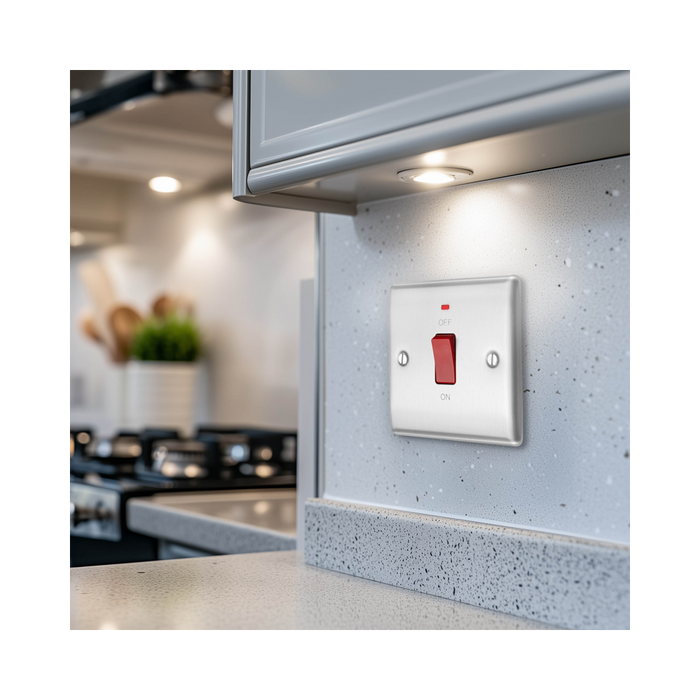 Metallic light switch with red toggle button on a white background kitchen setting