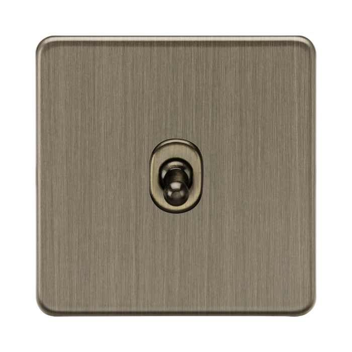 Antique Brass square light switch with central knob on a white background