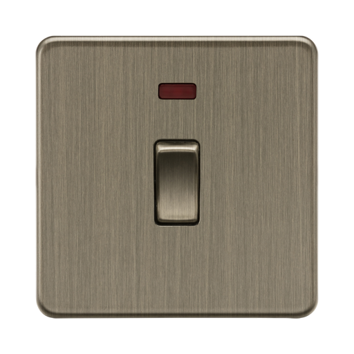 Antique Brass light switch with a red indicator on a white background